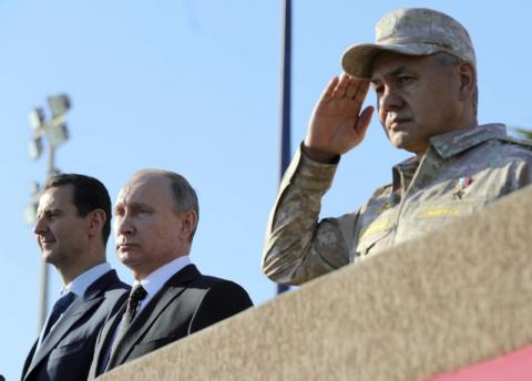 Russian President Vladimir Putin (C), Defence Minister Sergei Shoigu (R) and Syrian President Bashar al-Assad visit the Hmeymim air base in Latakia Province, Syria, December 11, 2017. PHOTO BY REUTERS/Sputnik/Mikhail Klimentyev