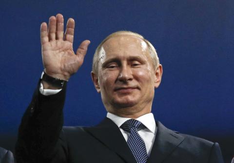 Russia's President Vladimir Putin waves during the closing ceremony for the 2014 Sochi Winter Olympics