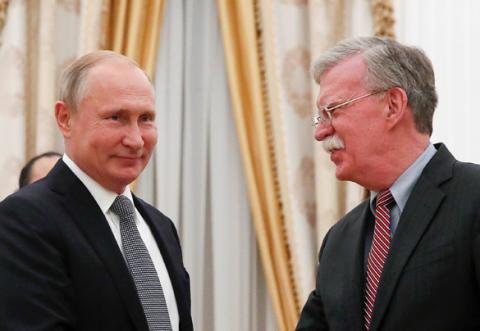 Russian President Vladimir Putin (L) greets U.S. national security adviser John Bolton during a meeting at the Kremlin in Moscow, Russia, October 23, 2018. PHOTO BY REUTERS/Maxim Shemetov