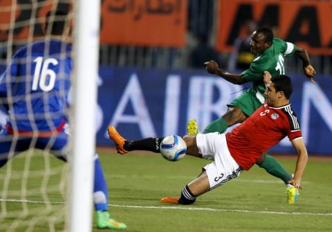 Egypt's Rami Rabia and Nigeria’s Aminu Umar in action in African Nations Cup qualifiers Group G in an Egypt v Nigeria game in Borg El Arab Stadium, Alexandria, Egypt 29/03/2016. PHOTO BY REUTERS/Amr Abdallah Dalsh