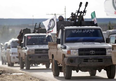 A Turkish-backed Syrian rebel rides on a truck with a mounted weapon at Manbij countryside, Syria, December 28, 2018. PHOTO BY REUTERS/Khalil Ashawi