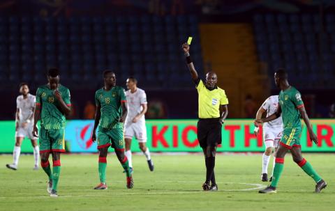 Mauritania's Moctar Sidi El Hacen is shown a yellow card by referee Louis Hakizimana. PHOTO BY REUTERS/Suhaib Salem