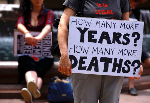 Refugee advocates hold placards as they participate in a protest in Sydney, Australia, against the treatment of asylum-seekers at Australia-run detention centres located at Nauru and Manus Island, November 18, 2017. PHOTO BY REUTERS/David Gray 