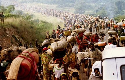 Rwandan refugees cross Rusumo border to Tanzania from Rwanda May 30, 1994 carrying their belongings even goats, mattresses and cows. PHOTO BY REUTERS/Jeremiah Kamau
