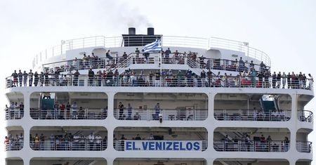 Syrian refugees are seen onboard passenger ship "Eleftherios Venizelos" as the ship arrives at the port of Piraeus near Athens, Greece, August 20, 2015. The ship was heading to the Greek mainland from islands in the Aegean Sea on Wednesday amid confusion over its final destination and the fate of passengers. PHOTO BY REUTERS/Stoyan Nenov