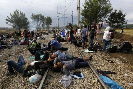 Syrian refugees sleep on rail tracks at the Greek-Macedonian border, near the village of Idomeni, August 22, 2015. PHOTO BY REUTERS/Yannis Behrakis