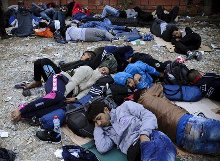 Migrants sleep at transit camp in Gevgelija, Macedonia, after entering the country by crossing the border with Greece, September 24, 2015. PHOTO BY REUTERS/Ognen Teofilovski