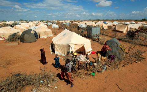 Refugees stand outside their tent at the Ifo Extension refugee camp in Dadaab, near the Kenya-Somalia border in Garissa County, Kenya, October 19, 2011. PHOTO BY REUTERS/Thomas Mukoya