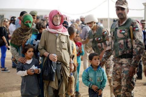 Syrian refugees wait to board a Jordanian army vehicle after crossing into Jordanian territory with their families, in Al Ruqban border area, near the northeastern Jordanian border with Syria, and Iraq, near the town of Ruwaished, 240 km east of Amman, September 10, 2015. PHOTO BY REUTERS/Muhammad Hamed