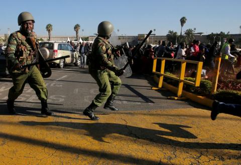 Riot police officers disperse workers to secure the Jomo Kenyatta International Airport during a labour dispute that grounded flights, near Nairobi, Kenya, March 6, 2019. PHOTO BY REUTERS/Thomas Mukoya
