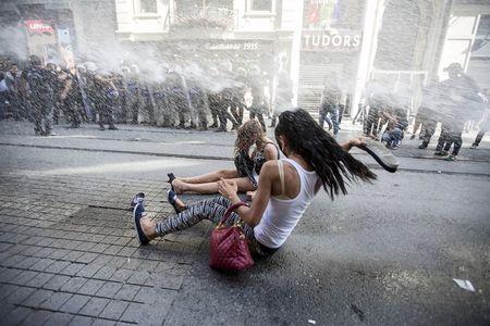 Riot police use a water cannon to disperse LGBT rights activist before a Gay Pride Parade in central Istanbul, Turkey, June 28, 2015. PHOTO BY REUTERS/Kemal Aslan
