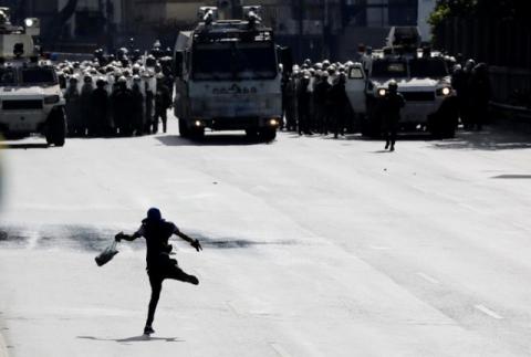 Riot security forces take up position as a demonstrator reacts in front of them while clashing with demonstrators rallying against Venezuela's President Nicolas Maduro in Caracas, Venezuela, June 10, 2017. PHOTO BY REUTERS/Carlos Garcia Rawlins