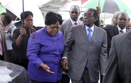 Zimbabwean President Robert Mugabe (R) is greeted by Vice President Joice Mujuru (L) in a file photo. PHOTO BY REUTERS/Stringer