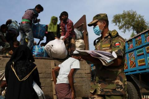 Newly arrived Rohingya refugees climb on a truck to get registered after crossing the Bangladesh-Myanmar border at a relief centre in the Teknaf area, Bangladesh, November 23, 2017. PHOTO BY REUTERS/Susana Vera