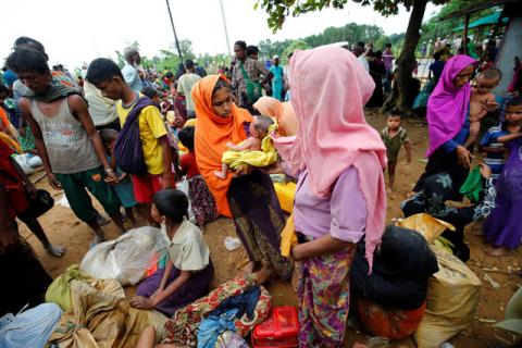 A newborn child is among fresh Rohingya refugees, who are waiting near the Kutupalang makeshift refugee camp, in Cox’s Bazar, Bangladesh, August 30, 2017. PHOTO BY REUTERS/Mohammad Ponir 
