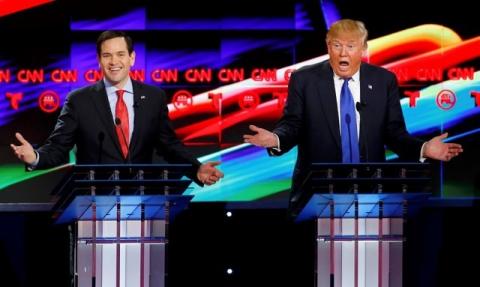 Republican U.S. presidential candidates Marco Rubio (L) and Donald Trump react to each other as they discuss an issue during the debate sponsored by CNN for the 2016 Republican U.S. presidential candidates in Houston, Texas, February 25, 2016. PHOTO BY REUTERS/Mike Stone