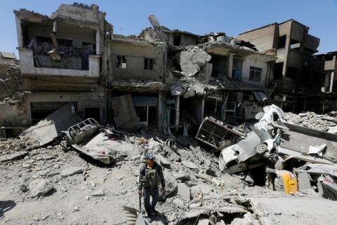 A member of Iraqi federal police patrols in the destroyed Old City of Mosul, Iraq, August 7, 2017. PHOTO BY REUTERS/Suhaib Salem
