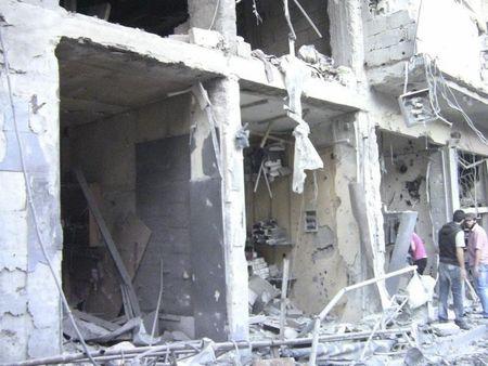 People look at damaged buildings at Al-Zabadani, August 8, 2012. PHOTO BY REUTERS/Shaam News Network