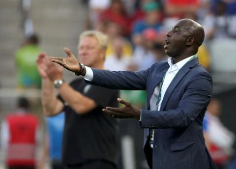 Nigeria's former head coach Samson Siasia (R) reacts next to Germany's head coach Horst Hrubesch during the second half. PHOTO BY REUTERS/Paulo Whitaker