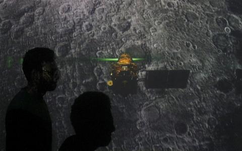 Student walk past a screen during a live streaming of Chandrayaan-2 landing at an educational institute in Mumbai, India, September 7, 2019. PHOTO BY REUTERS/Francis Mascarenhas