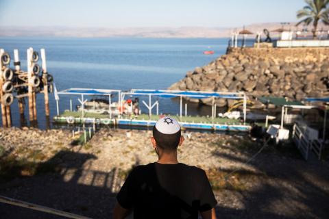 A youth wearing a yarmulke with a Star of David looks towards a temporary pier at the Sea of Galilee in northern Israel, November 1, 2018. PHOTO BY REUTERS/Ronen Zvulun
