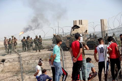 Iraqi security forces stand guard inside the west Qurna 2 oilfield, during a protest in north Basra, Iraq, July 14, 2018. PHOTO BY REUTERS/Essam al-Sudani