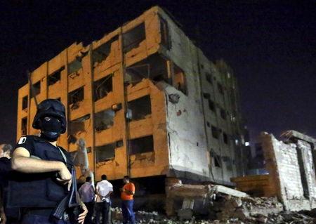A security official stands guard at the site of a bomb blast at a national security building in Shubra Al-Khaima, on the outskirts of Cairo, August 20, 2015. PHOTO BY REUTERS/Mohamed Abd El Ghany