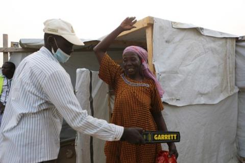 A security officer scans a woman entering a health clinic at Minawao refugee camp in Minawao, Cameroon, March 15, 2016. PHOTO BY REUTERS/Joe Penney