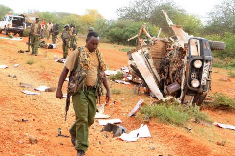 A Kenyan security person walk past a police vehicle damaged by a blast killing Kenyan police officers at the Garissa county, eastern Kenya, May 24, 2017. PHOTO BY REUTERS/Stringer