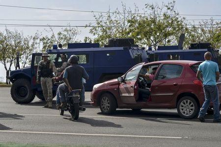 Armoured vehicles are seen along a road after the arrival of a Brazilian senators delegation near the Simon Bolivar airport in Caracas, June 18, 2015. PHOTO BY REUTERS/Carlos Becerra