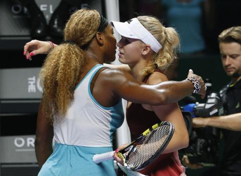Serena Williams of the U.S. is congratulated by Caroline Wozniacki of Denmark during their WTA Finals singles semi-final tennis match at the Singapore Indoor Stadium, October 25, 2014. PHOTO BY REUTERS/Edgar Su