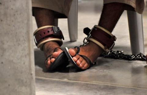 A Guantanamo detainee's feet are shackled to the floor as he attends a "Life Skills" class inside the Camp 6 high-security detention facility at Guantanamo Bay U.S. Naval Base April 27, 2010. PHOTO BY REUTERS/Michelle Shephard