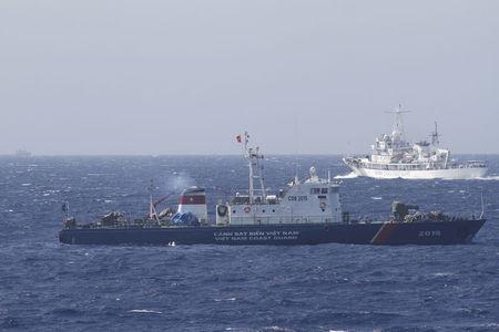 A ship (top) of Chinese Coast Guard is seen near a ship of Vietnam Marine Guard in the South China Sea, about 210 km (130 miles) off shore of Vietnam, May 14, 2014. PHOTO BY REUTERS/Nguyen Minh