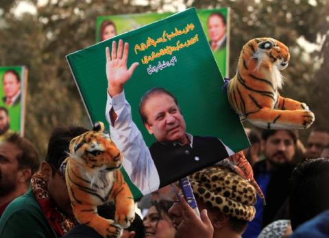 A supporter of the ruling Pakistan Muslim League (Nawaz) (PML-N) holds a picture of Nawaz Sharif outside the accountability court where he appeared to face corruption charges filed against him, in Islamabad, Pakistan, November 3, 2017. PHOTO BY REUTERS/Faisal Mahmood