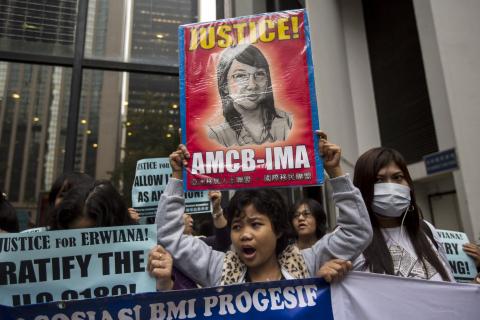 A supporter holds up a sign with a drawing of Indonesian domestic helper Erwiana Sulistyaningsih, during a protest calling for better protection of migrant workers, outside the district court in Hong Kong, February 27, 2015. PHOTO BY REUTERS/Tyrone Siu