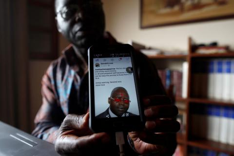 Simon Munzu, a former UN official, who is campaigning for peace in the Anglophone regions of Cameroon, shows a threat message posted against him on social media by separatists during an interview with Reuters in Yaounde, Cameroon, October 3, 2018. PHOTO BY REUTERS/Zohra Bensemra
