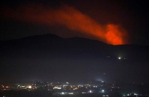 Smoke rises past a mountain as seen from Damascus countryside, Syria, December 25, 2018. PHOTO BY REUTERS/Omar Sanadiki