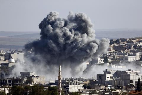 Smoke and dust rise over Syrian town of Kobani after an airstrike, as seen from the Mursitpinar crossing on the Turkish-Syrian border in the southeastern town of Suruc in Sanliurfa province, October 23, 2014. PHOTO BY REUTERS/Kai Pfaffenbach