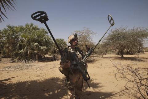 A French soldier carries mine detection equipment to search for mines outside Gao, Mali, March 9 2013. PHOTO BY REUTERS/Emmanuel Braun