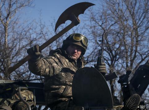A member of the Ukrainian armed forces rides an armoured personnel carrier near Artemivsk, eastern Ukraine, February 22, 2015. PHOTO BY REUTERS/Gleb Garanich