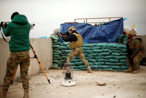 A member of the Iraqi rapid response forces fires during a battle with Islamic State militants at the Tigris river frontline near Mosul, Iraq, January 25, 2017. PHOTO BY REUTERS/Ahmed Jadallah