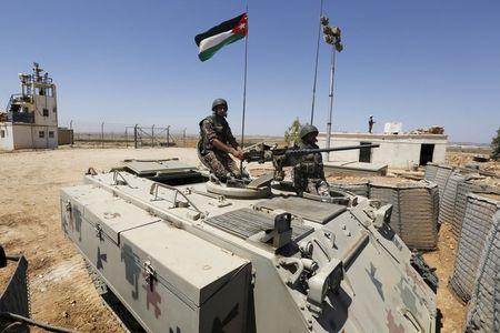 Soldiers stand guard on a tank at the Jordanian-Syrian border, near Mafraq, Jordan, August 16, 2015. PHOTO BY REUTERS/Muhammad Hamed