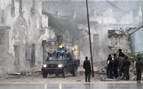 A Somali government soldier holds his fighting position against suspected militants during an attack at the Jilacow underground cell inside a national security compound in Mogadishu