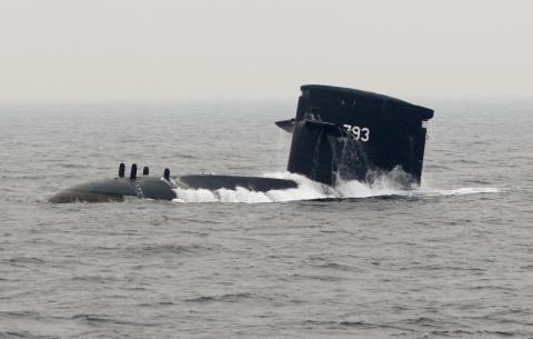A Taiwan Navy SS-793 Hai Lung diesel-electric submarine emerges from underwater during a naval demonstration near a military naval base in Kaohsiung, southern Taiwan, January 22, 2013. PHOTO BY REUTERS/Pichi Chuang