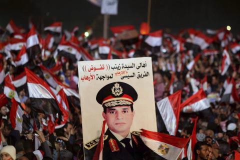 Supporters of Egypt's army chief General Abdel Fattah al-Sisi holds a poster of Sisi in Tahrir square in Cairo, on the third anniversary of Egypt's uprising
