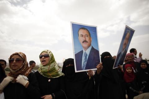 Supporters of Yemen's former President Ali Abdullah Saleh hold posters of Saleh outside the al-Saleh mosque after weekly Friday prayers in Sanaa