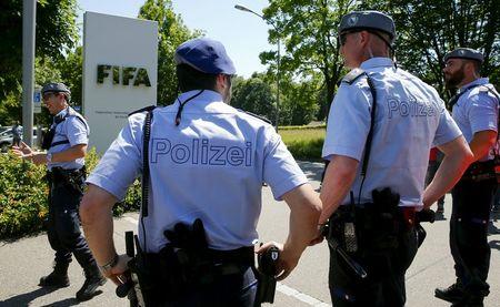Swiss police officers stand in front of the entrance of the FIFA headquarters in Zurich, Switzerland, June 3, 2015. PHOTO BY REUTERS/Arnd Wiegmann
