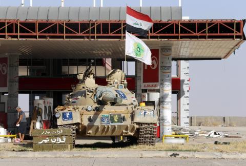 A tank belonging to the Shi'ite Badr Brigade militia takes position in front of a gas station in Suleiman Beg, northern Iraq, September 9, 2014. PHOTO BY REUTERS/Ahmed Jadallah