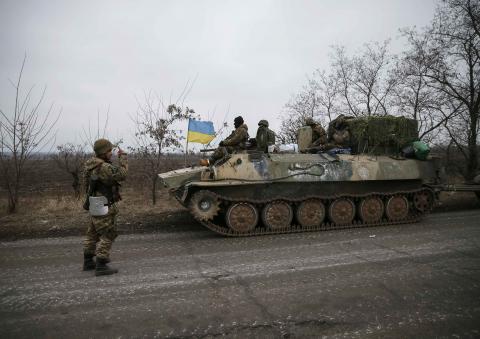 A convoy of Ukrainian armed forces including armoured personnel carriers, military vehicles and cannons prepare to move as they pull back from the Debaltseve region, in Paraskoviyvka, eastern Ukraine, February 26, 2015. PHOTO BY REUTERS/Gleb Garanich