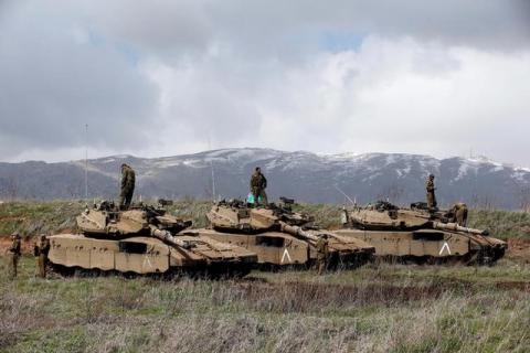 Israeli soldiers stand atop tanks in the Golan Heights near Israel's border with Syria, March 19, 2014. PHOTO BY REUTERS/Ronen Zvulun